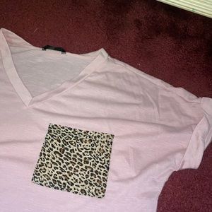A blush pink t shirt. Slightly opaque.. with a cheetah pocket